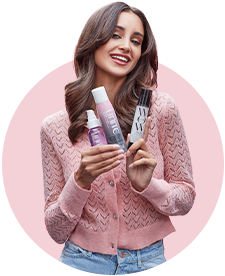 Woman holding Blo Blow Dry bar product lines